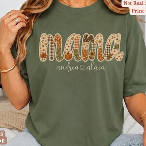 Personalized Mama Comfort Colors shirt with custom kids names, fall patchwork letters, pumpkins, florals, and faux embroidery effect in warm autumn tones on a moss tee.
