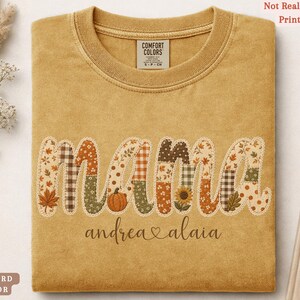 Personalized Mama Comfort Colors shirt with custom kids names, fall patchwork letters, pumpkins, florals, and faux embroidery effect in warm autumn tones on a mustard tee.