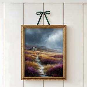 May include: A framed landscape painting depicts a path leading to a small house under a stormy sky. The artwork features a gold frame and is suspended by a green ribbon. The scene includes purple and yellow wildflowers.