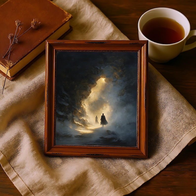 May include: A framed artwork with a dark, moody landscape scene. The painting depicts two figures walking towards a bright light within a cave-like structure. The frame is a warm, reddish-brown color. A cup of tea and a book are also in the image.