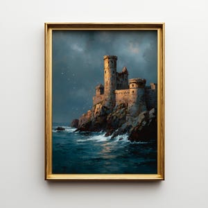 May include: A framed painting depicts a medieval castle perched on a rocky cliff overlooking a turbulent sea. The castle, with its stone towers and walls, is bathed in warm light against a dramatic, stormy sky. The artwork is framed in a gold-colored frame.