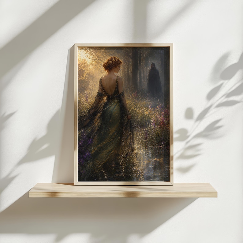 May include: Framed art print depicting a woman in an elegant gown walking through a sunlit forest path. The artwork features a palette of greens, golds, and purples, with a figure in the distance. The print is displayed on a wooden shelf against a white wall.