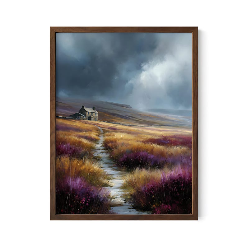 May include: A framed landscape painting depicts a stone cottage on a hillside path. The artwork features a field of purple and gold grasses under a dramatic, cloudy sky. The wooden frame adds a rustic touch to the artwork.