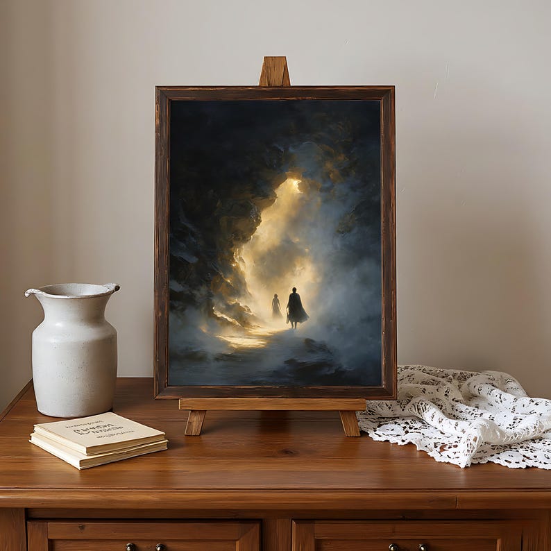 May include: A framed artwork on a wooden easel depicts two figures walking towards a bright light. The painting features a dark, cloudy sky with a golden glow in the center. The frame is dark brown.