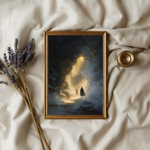 May include: A framed art print with a gold frame depicts two figures walking towards a bright light in a cave. The artwork is in shades of blue, gold, and black. A bundle of lavender and a small gold object are next to the frame.