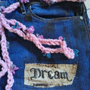 Patchwork Boho AppliquePatched Upcycled Cropped DarkerDenim Cuffed or Straight Jeans SIZE 14 TO 16 Stretch VintageStyledenim.   Inseam 26.  Vintage-look handpainted throughout Flowers, Birds, Cat, and appliques of various designs.  Handmade and handcrafted.   Unique Applique Jeans Distressed.  Highrise High Waisted, Handpainted Handmade Appliqued Straight Style Jeans. Size 14 to 16 depending on your measurements.  Check the measurements.  Handmade Boho Sash Bohemian design crocheted with bells.