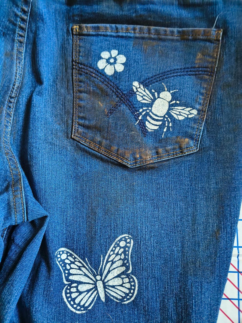 Patchwork Boho AppliquePatched Upcycled Cropped DarkerDenim Cuffed or Straight Jeans SIZE 14 TO 16 Stretch VintageStyledenim.   Inseam 26.  Vintage-look handpainted throughout Flowers, Birds, Cat, and appliques of various designs.  Handmade and handcrafted.   Unique Applique Jeans Distressed.  Highrise High Waisted, Handpainted Handmade Appliqued Straight Style Jeans. Size 14 to 16 depending on your measurements.  Check the measurements.  Handmade Boho Sash Bohemian design crocheted with bells.