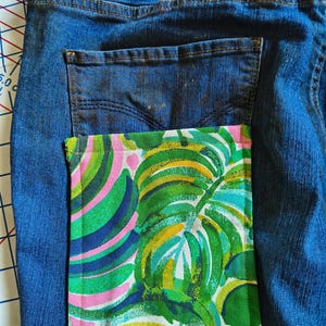 Patchwork Boho AppliquePatched Upcycled Cropped DarkerDenim Cuffed or Straight Jeans SIZE 14 TO 16 Stretch VintageStyledenim.   Inseam 26.  Vintage-look handpainted throughout Flowers, Birds, Cat, and appliques of various designs.  Handmade and handcrafted.   Unique Applique Jeans Distressed.  Highrise High Waisted, Handpainted Handmade Appliqued Straight Style Jeans. Size 14 to 16 depending on your measurements.  Check the measurements.  Handmade Boho Sash Bohemian design crocheted with bells.