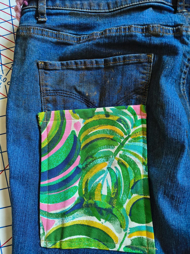 Patchwork Boho AppliquePatched Upcycled Cropped DarkerDenim Cuffed or Straight Jeans SIZE 14 TO 16 Stretch VintageStyledenim.   Inseam 26.  Vintage-look handpainted throughout Flowers, Birds, Cat, and appliques of various designs.  Handmade and handcrafted.   Unique Applique Jeans Distressed.  Highrise High Waisted, Handpainted Handmade Appliqued Straight Style Jeans. Size 14 to 16 depending on your measurements.  Check the measurements.  Handmade Boho Sash Bohemian design crocheted with bells.