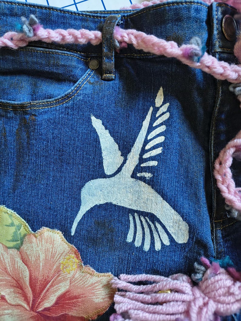 Patchwork Boho AppliquePatched Upcycled Cropped DarkerDenim Cuffed or Straight Jeans SIZE 14 TO 16 Stretch VintageStyledenim.   Inseam 26.  Vintage-look handpainted throughout Flowers, Birds, Cat, and appliques of various designs.  Handmade and handcrafted.   Unique Applique Jeans Distressed.  Highrise High Waisted, Handpainted Handmade Appliqued Straight Style Jeans. Size 14 to 16 depending on your measurements.  Check the measurements.  Handmade Boho Sash Bohemian design crocheted with bells.