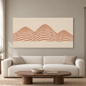 Könnte beinhalten: Ein rechteckiges Wandbild auf Leinwand mit einer horizontalen Landschaftsdarstellung von drei abgerundeten Hügeln. Die Hügel sind in Terrakotta-Orange gehalten und zeigen ein Muster aus wellenförmigen, konzentrischen Linien auf beigem Grund.