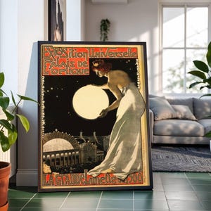 May include: Framed vintage poster with the text "Exposition Universelle Palais de L'Optique" and "La Grande Lunette 1900". The poster features a woman holding a large, glowing orb against a starry night sky. The poster has a black frame.