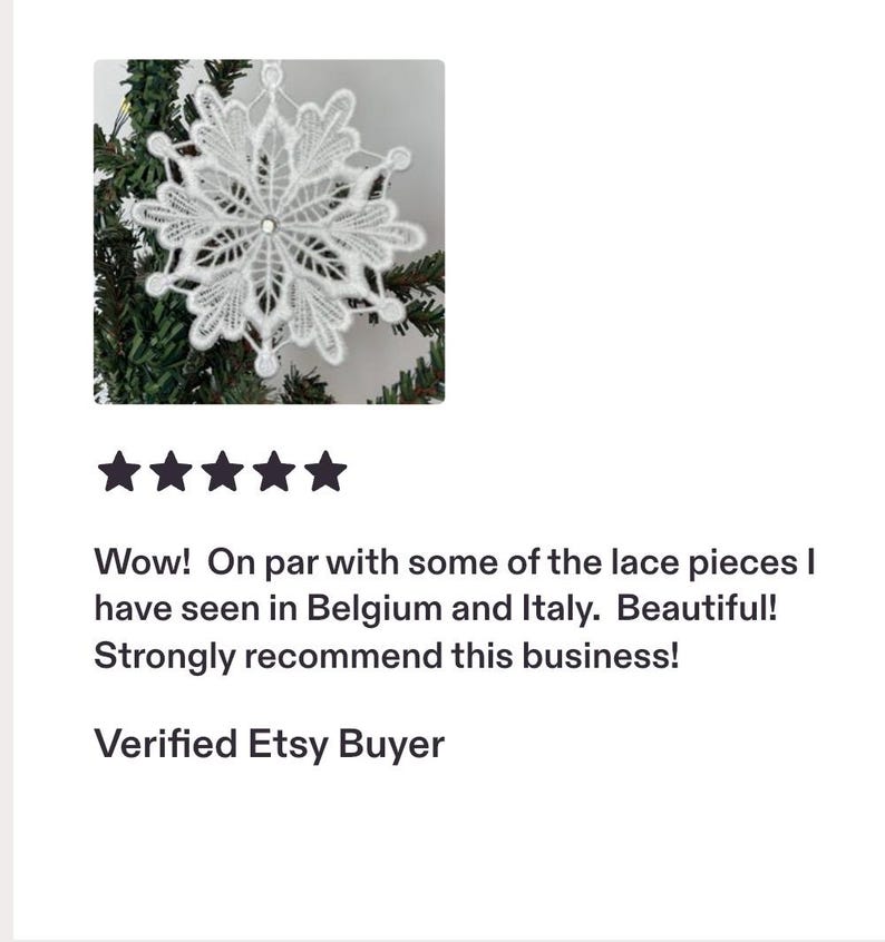 May include: A white lace snowflake ornament featuring intricate threadwork and a small central crystal accent. The snowflake has six symmetrical points with delicate, leaf-like patterns and a small loop at the top for hanging on a tree branch.