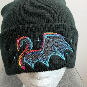Winter Hat Dragon Design Black Beanie Knit Headwear Warm Fleece Lined Cap Mythical Creature Embroidery Cold Weather Essential Acrylic Material Soft Comfortable Fit Unisex Style Fantasy Inspired Accessory Gothic Fashion Statement Blue Pink