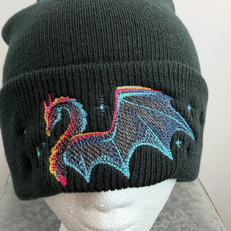 Winter Hat Dragon Design Black Beanie Knit Headwear Warm Fleece Lined Cap Mythical Creature Embroidery Cold Weather Essential Acrylic Material Soft Comfortable Fit Unisex Style Fantasy Inspired Accessory Gothic Fashion Statement Blue Pink