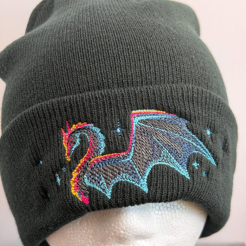 Gothic Dragon Beanie Fantasy Winter Hat Black Knit Cap Embroidered Mythical Beast Warm Headwear Alternative Fashion Accessory Fleece Lined Comfort Unisex Design Cold Weather Protection Blue Pink Embroidery Detail Unique Pattern Style