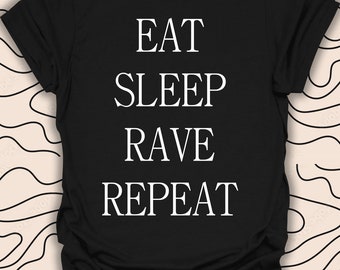 May include: Black t-shirt with white text that reads "Eat Sleep Rave Repeat".