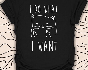 May include: Black t-shirt with a white graphic of a cat giving the middle finger with the text "I do what I want" printed on it.