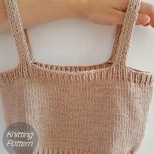 May include: A knitted beige crop top with thin straps. The top is made with a simple stitch pattern and has a square neckline. The text "Knitting Pattern" is visible in the lower left corner of the image.