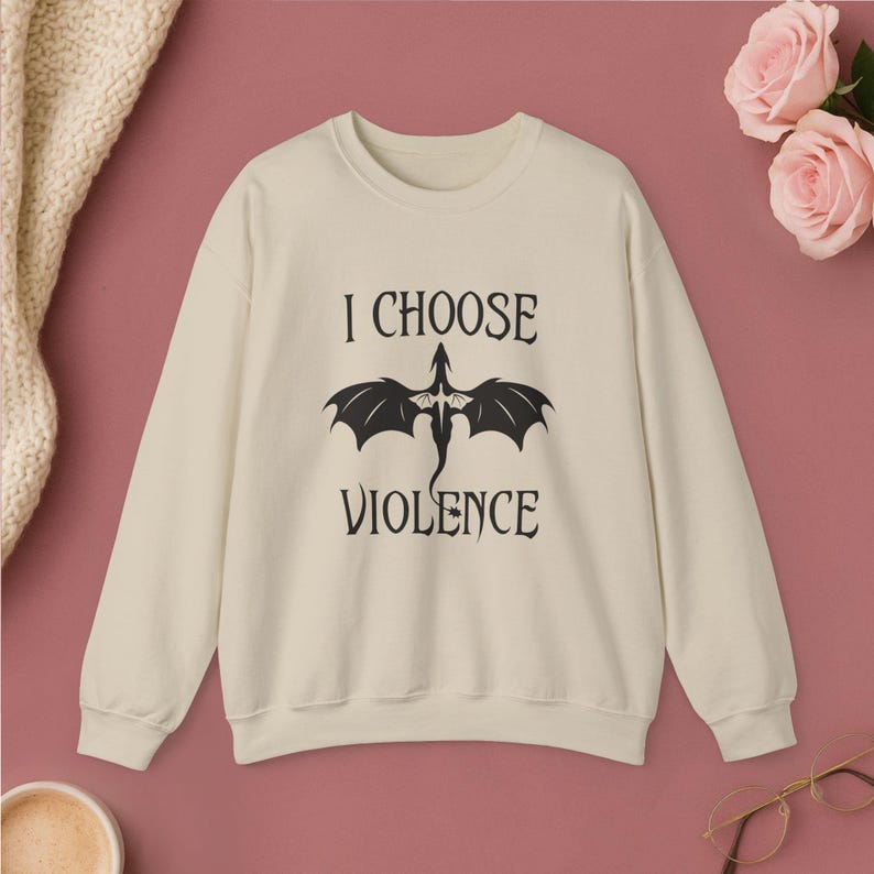 Comfortable navy crewneck sweatshirt. Striking white graphic design on the front features a majestic Dragon, boldly proclaiming the phrase I Chose Violence a statement that's sure to resonate with fans of intense, passionate relationships.