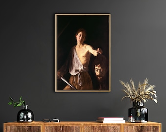 May include: A painting depicting a young person holding a sword and a severed head. The person is wearing a white tunic and the head is covered in a dark cloth. The painting has a dark background.
