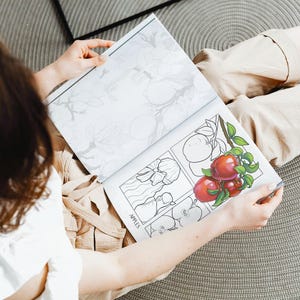 Woman coloring in apples