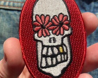 small skull patch with shiny gold toof