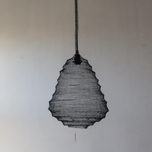 May include: A black metal pendant light fixture shaped like a teardrop with a delicate, intricate woven design.