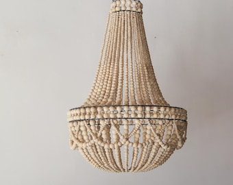 May include: A large, wooden bead chandelier with a metal frame. The beads are natural in colour and create a cascading effect.