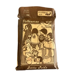 May include: A brown paper envelope with a vintage sewing pattern for children's clothing. The pattern is called "Folkwear 109" and features a group of children wearing various ethnic-inspired outfits. The envelope also includes the text "Little Folks" and "Ethnic Patterns".