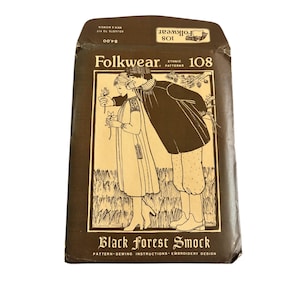 May include: A brown paper pattern envelope for a Black Forest Smock sewing pattern. The envelope features a black and white illustration of a couple in traditional folkwear. The text on the envelope reads "Folkwear. Ethnic Patterns 108 Black Forest Smock Pattern Sewing Instructions Embroidery Design."