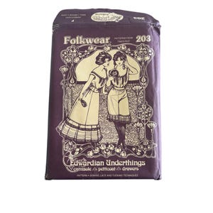 May include: A vintage sewing pattern envelope for Edwardian Underthings, featuring a drawing of two women wearing camisoles, petticoats, and drawers. The pattern includes instructions for sewing lace and tucking techniques. The envelope is purple with gold lettering and a floral design.