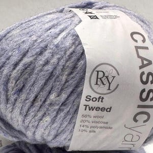 May include: A skein of blue yarn labeled "CLASSIC Yarn" with the brand name "Ry" and the text "Soft Tweed" with the yarn composition: 56% wool, 20% viscose, 14% polyamide, 10% silk.
