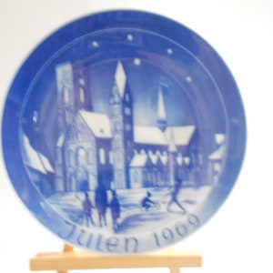May include: Blue and white Christmas plate with a snowy church scene and the text "Julen 1969".
