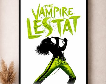 May include: A framed poster featuring the text "The Vampire Lestat" in green, above a silhouette of a person singing into a microphone. The person is wearing green pants with a black belt. The background is white.