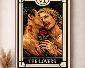 May include: A framed tarot card print featuring two men in an embrace, with a red rose between them. The card is labeled "THE LOVERS" and "VI" at the top. The artwork has a vintage, illustrative style with a dark color palette.