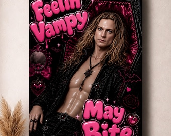 May include: A rectangular wall art print featuring a person with long wavy hair lying in a black coffin with pink satin lining. The text reads Feelin' Vampy and May Bite in bold pink bubble letters. The design includes bats, hearts, and roses.