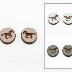 May include: Three pairs of wooden earrings with a horse silhouette design. The earrings are in three colors: light brown, light blue, and gray.