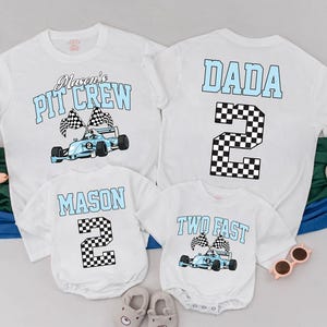May include: White t-shirts and onesies with racing-themed graphics. The shirts feature the text "Mason's Pit Crew" and "DADA 2", while the onesies say "MASON 2" and "TWO FAST". Each design includes a race car and checkered flags.
