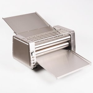 May include: A stainless steel pasta machine with a rectangular body, two rollers, and a wire rack. The machine has a hinged top and a pull-out tray. The control panel has a speed setting and power switch.