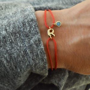 May include: A white ceramic mug with a black handle and the text "But First, Coffee" in a black, bold font. The mug is on a white surface. The mug is approximately 4 inches tall.