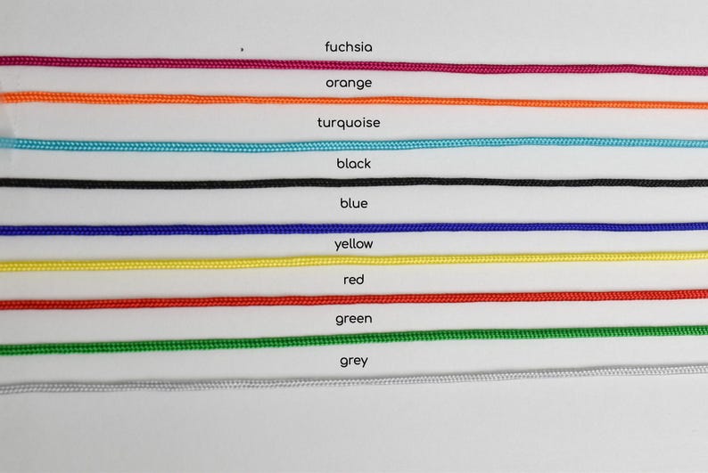 May include: A selection of colorful cords in fuchsia, orange, turquoise, black, blue, yellow, red, green, and grey. Each cord is labeled with its respective color name.