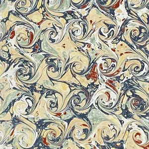 Papel jaspeado, estampado de rizos franceses, tonos tierra, azul prusiano, ocre naranja.