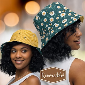 May include: Reversible bucket hat with a daisy and bee print on one side and a honeycomb pattern on the other side. The hat is made of a soft, comfortable fabric and is perfect for everyday wear.