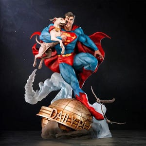 May include: A Superman statue holding a dog, posed dynamically. The figure is in a blue suit with a red “S” emblem, red boots, and a flowing red cape. It stands on a golden globe with the words “Daily Planet.”