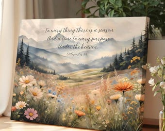 May include: A rectangular canvas print featuring a landscape of rolling hills, distant mountains, and a meadow filled with wildflowers in shades of white, yellow, and pink. The text reads: To every thing there is a season And a time to every purpose Under the heaven. Ecclesiastes 3:1.