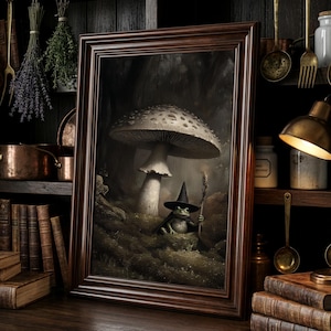 May include: A framed picture depicting a frog in a witch's hat and cloak, holding a staff under a large mushroom. The artwork is set in a dark, forest-like environment. The frame is a dark brown colour.