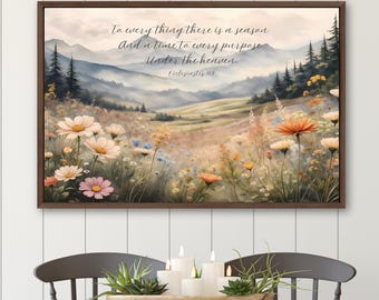 Peut inclure: Une impression murale rectangulaire dans un cadre marron foncé représentant un paysage de prairie fleurie avec des montagnes en arrière-plan. Le texte indique : To every thing there is a season And a time to every purpose Under the heaven. Ecclesiastes 3:1.