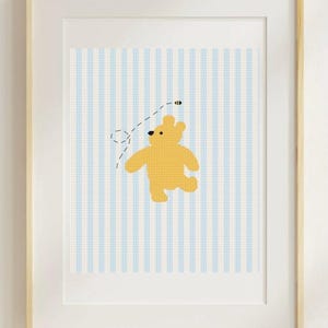 May include: A framed print featuring a yellow bear illustration with a bee on a blue and white striped background. The artwork is in a wooden frame, suitable for nursery or children's room decor.