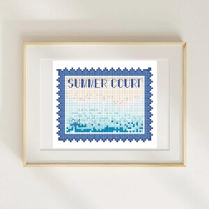 May include: A framed cross-stitch artwork featuring a beach scene within a blue postage stamp design. The words "SUMMER COURT" are stitched across the top. The artwork is framed in a light wood frame.